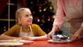 Elderly lady putting chocolate muffins on table, Christmas preparations, holiday Royalty Free Stock Photo