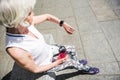 Elderly lady relaxing after sport activities outside building Royalty Free Stock Photo