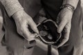 Elderly lady`s hands checking money in her purse.