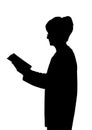 Elderly lady silhouette standing reading book