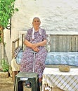 Elderly lady sitting in her garden