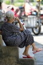 Elderly Lady Sitting on Step