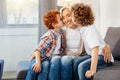 Elderly lady smiling while grandsons kissing her Royalty Free Stock Photo