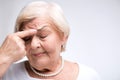 Elderly lady touching her head with finger Royalty Free Stock Photo