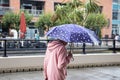 08/12/2019 Portsmouth, Hampshire, UK An elderly lady walking in the rain holding and umbrella