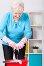 Elderly lady wringing cloth