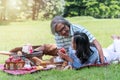 Elderly lifestyle concept. Happiness couple relax together in the public park. Husband embracing and holding red apple for Royalty Free Stock Photo