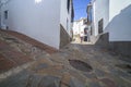 Elderly local man climbing slope narrow street of Comares, Malaga, Spain
