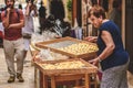 Elderly local woman selling fresh orecchiette or orecchietta to tourists in Bari old town