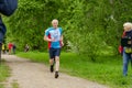 An elderly male athlete finishes a distance in a running competition among senior athletes