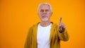 Elderly male in casual clothes showing warning finger gesture, rejection sign Royalty Free Stock Photo