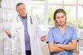 Elderly man and adult woman medics swear in medical office Royalty Free Stock Photo