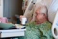 Elderly male hospital patient drinks water Royalty Free Stock Photo