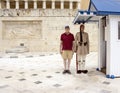 Elderly male tourist standing by a Gaurd