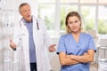 Elderly man and adult woman medics swear in medical office Royalty Free Stock Photo