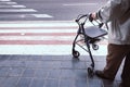 Elderly man alone disabled, using a walker to help him walk Royalty Free Stock Photo