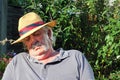 Elderly man asleep wearing hat. Royalty Free Stock Photo