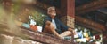 An elderly man with a beard meditates in a Buddhist temple. Peace and tranquility, satisfaction from silence