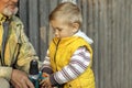 An elderly man with a beard shows the child how a screwdriver works. Royalty Free Stock Photo