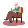 Elderly man with a beard sits in a chair and reads a book.