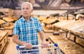 mature senor choosing bread and baking in grocery section of supermarket Royalty Free Stock Photo