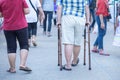 Elderly man with a cane walking in a city Park. Royalty Free Stock Photo