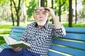 Elderly man in casual reading outdoors