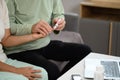 Elderly man checking blood sugar of his diabetic wife at home. Elderly healthcare concept Royalty Free Stock Photo