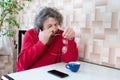 An elderly man is checking his eye after long reading on his phone. Eye pain Royalty Free Stock Photo