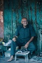 old stone seller at the market smiling