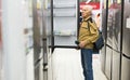 elderly man choosing refrigerator in showroom of electrical appliance store Royalty Free Stock Photo