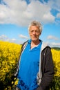 Elderly man in coleseed Royalty Free Stock Photo