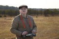 An elderly man controls a radio-controlled aircraft using the remote control Royalty Free Stock Photo