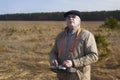 An elderly man controls a radio-controlled aircraft using the remote control Royalty Free Stock Photo