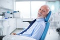 Elderly man in dentist`s chair without fear waiting for treatmen Royalty Free Stock Photo