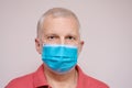 Elderly man in a disposable protective mask