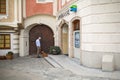 An elderly man with a dog at the building of Savings bank. Austria.