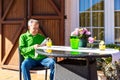 Elderly man drinking a lemon soda on the porch of his home on a spring day. Royalty Free Stock Photo