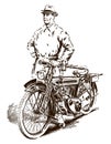 Elderly man from the early 20th century standing next to his classic motorcycle