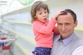 Elderly man at empty shelves in shop with child