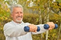 Elderly man exercising with dumbbells Royalty Free Stock Photo