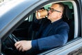 Elderly man experience self-driving smart car and has a cup of coffee Royalty Free Stock Photo