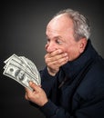 Elderly man with fan of dollars Royalty Free Stock Photo