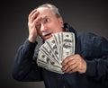 Elderly man with fan of dollars Royalty Free Stock Photo