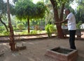 Elderly man feeding squirrels at garden