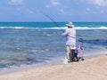 Elderly man fishing with a fishing rod