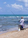 Elderly man fishing with a fishing rod