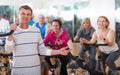 Elderly man on fitness cycle in fitness club