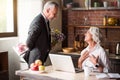 Elderly man giving flowers to his dear wife Royalty Free Stock Photo