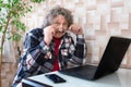 An elderly man in glasses working at the laptop Royalty Free Stock Photo